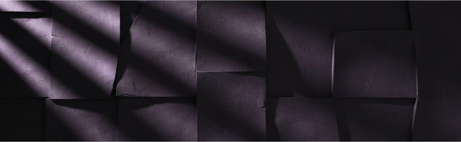 Folded violet panels catching a low raking light
